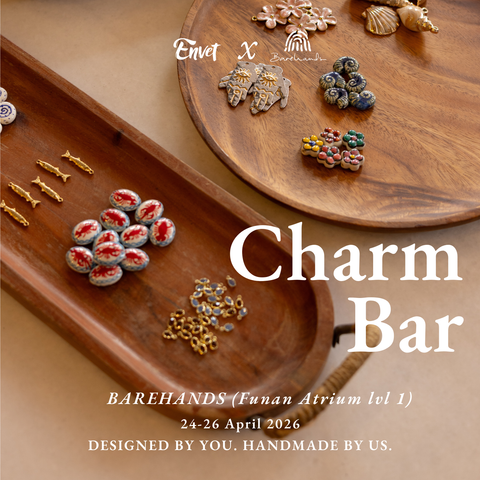 Wooden charm bar with various charms and promotional text for an event.